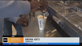Levan Reid tests his barista skills at Aroma Joe's in Tewksbury