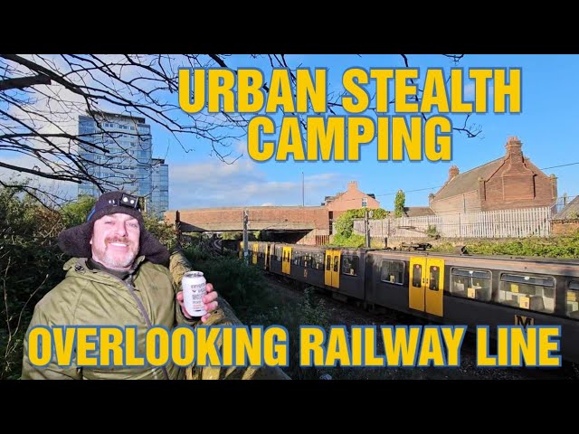URBAN STEALTH CAMP OVERLOOKING BUSY RAILWAY LINE class=