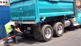 Double dump truck loads trailer