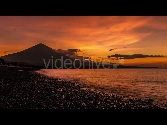 Sunset in Ocean And The Volcano Gunung Agung in Bali, Indonesia by Timelapse4K class=