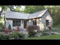 Old 1900's log gatehouse reinvented as an English-style Limestone cottage in Minnesota