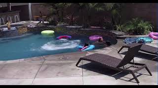 Boys run to jump off ledge to do front flips then one boy slips and hurt stomach (Security camera)