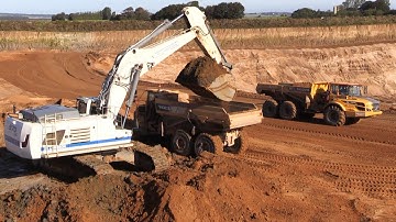 The Big White Liebherr R970 SME Loading Overburden With An Volvo A30G LGP Leveling The Haul Road