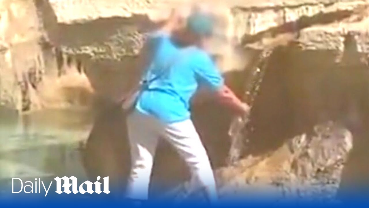 Unbelievable footage of woman walking into Trevi fountain to fill her water bottle