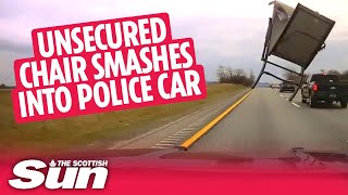 Unsecured chair smashes in police car on highway