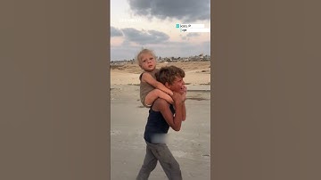 Displaced Gaza child carries sister south amid Israeli offensive