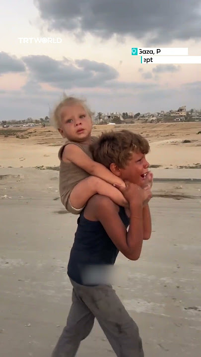 Displaced Gaza child carries sister south amid Israeli offensive