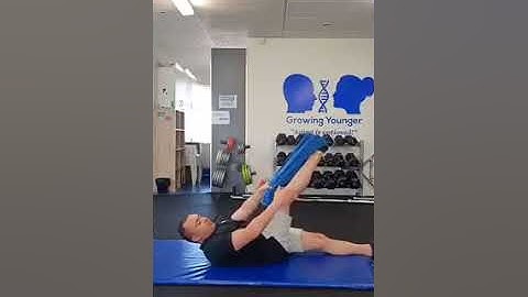 Hamstring stretch with towel for lower back pain