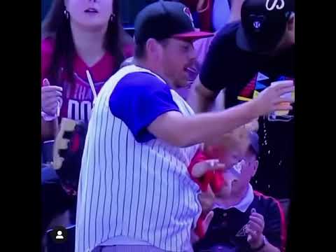 Diamondbacks fan catches foul ball with 1 hand while holding a baby