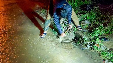 Removal Mud And Trash Clogged Culvert Drain On Street Road While Raining
