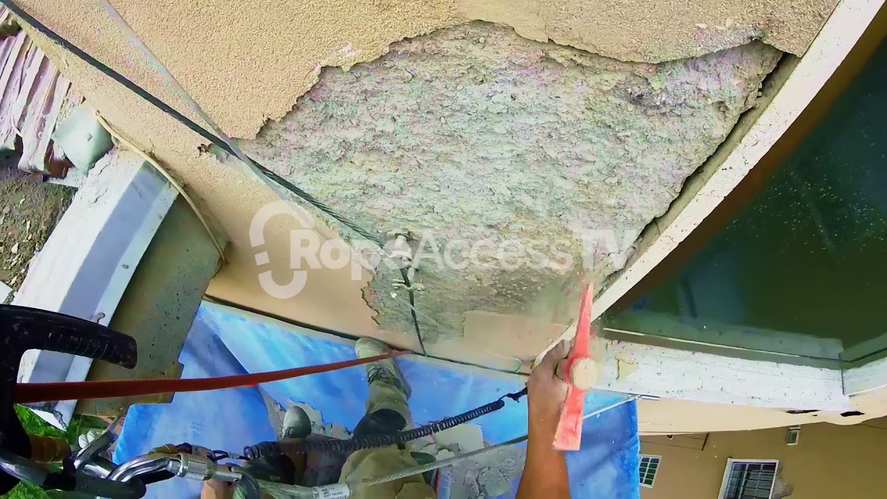 High rise technician repairs a falling wall - YouTube