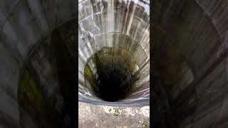 dropping rock in deep hole