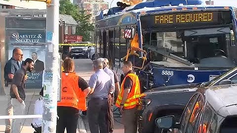 8 people injured after MTA bus jumps curb, takes down traffic light in Queens