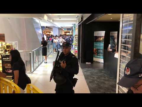 Police officers seen outside Huawei store at Nex shopping centre