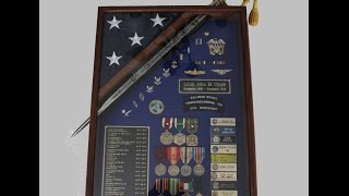 DIY, How to place a sword through a shadow box. In this video I continue the second part of a previous video that expalains in much more detail how to place a sword (Navy Cutlass)