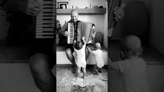 Granpa Playing Accordion To Twin Babies