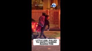 Little girl pulled to safety during raging fire