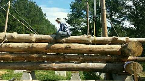 Pounding rebar into logs by hand