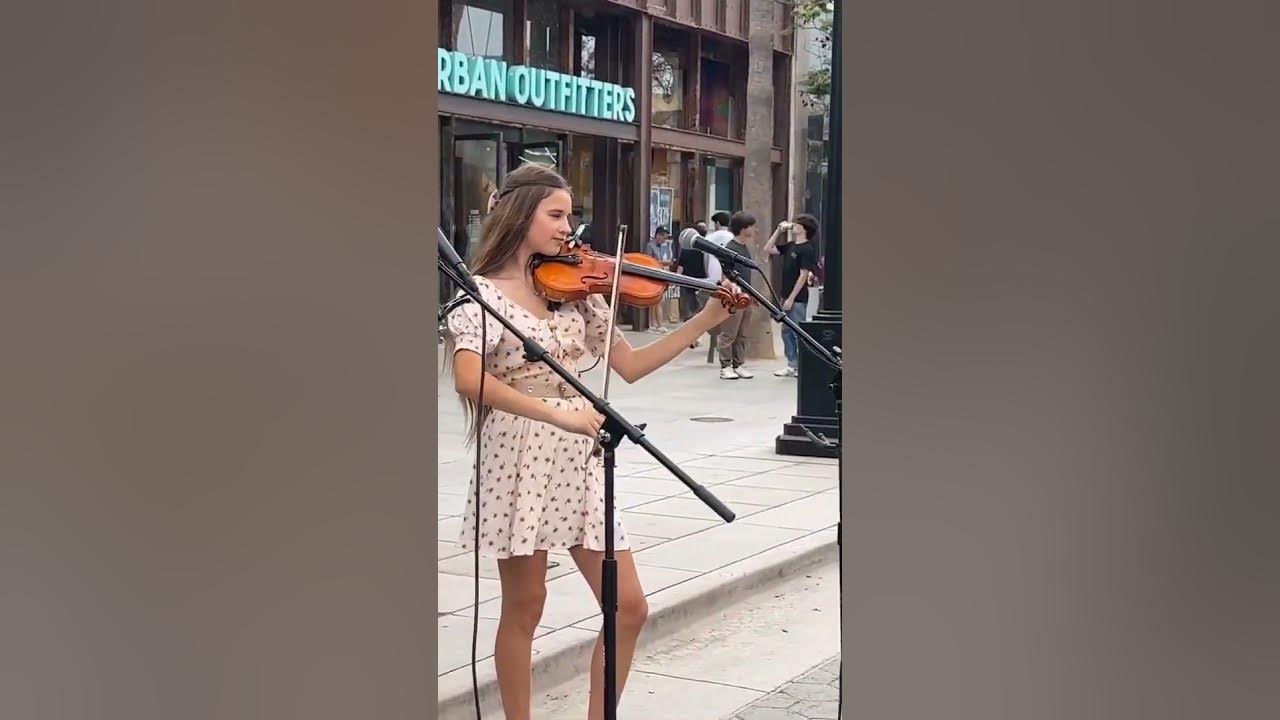 Karolina Protsenko tunes her violin before Stand by Me Violin Cover