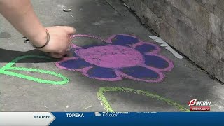 Art gallery places chalk around downtown Topeka for public to draw on sidewalks