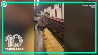 WATCH: Man jumps onto subway tracks to save another man's life