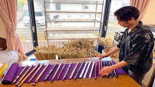 The process of making a traditional Japanese flute Shinobue. Japanese flute craftsman.