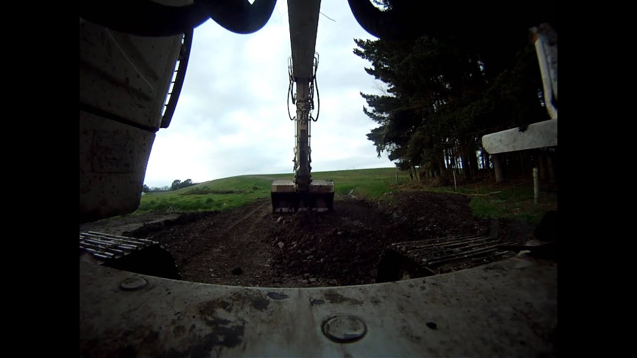 Excavator cleaning up pile of dirt