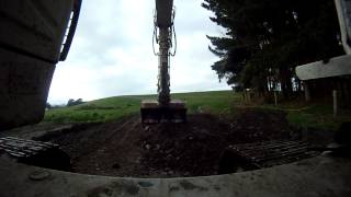 Excavator cleaning up pile of dirt