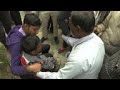 Relatives of india fire victims gather at morgue