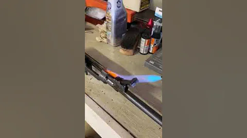 Cleaning a rifle sight with a blow torch