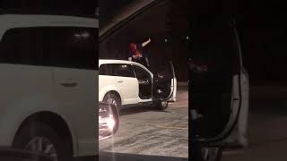 Girl dances on top of hood of minivan then car starts to drive and she falls off