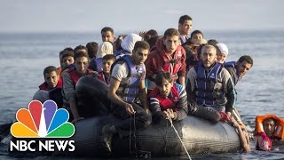 Syrian Refugees Come Ashore In Greece As Beachgoers Watch | Short Take | NBC News