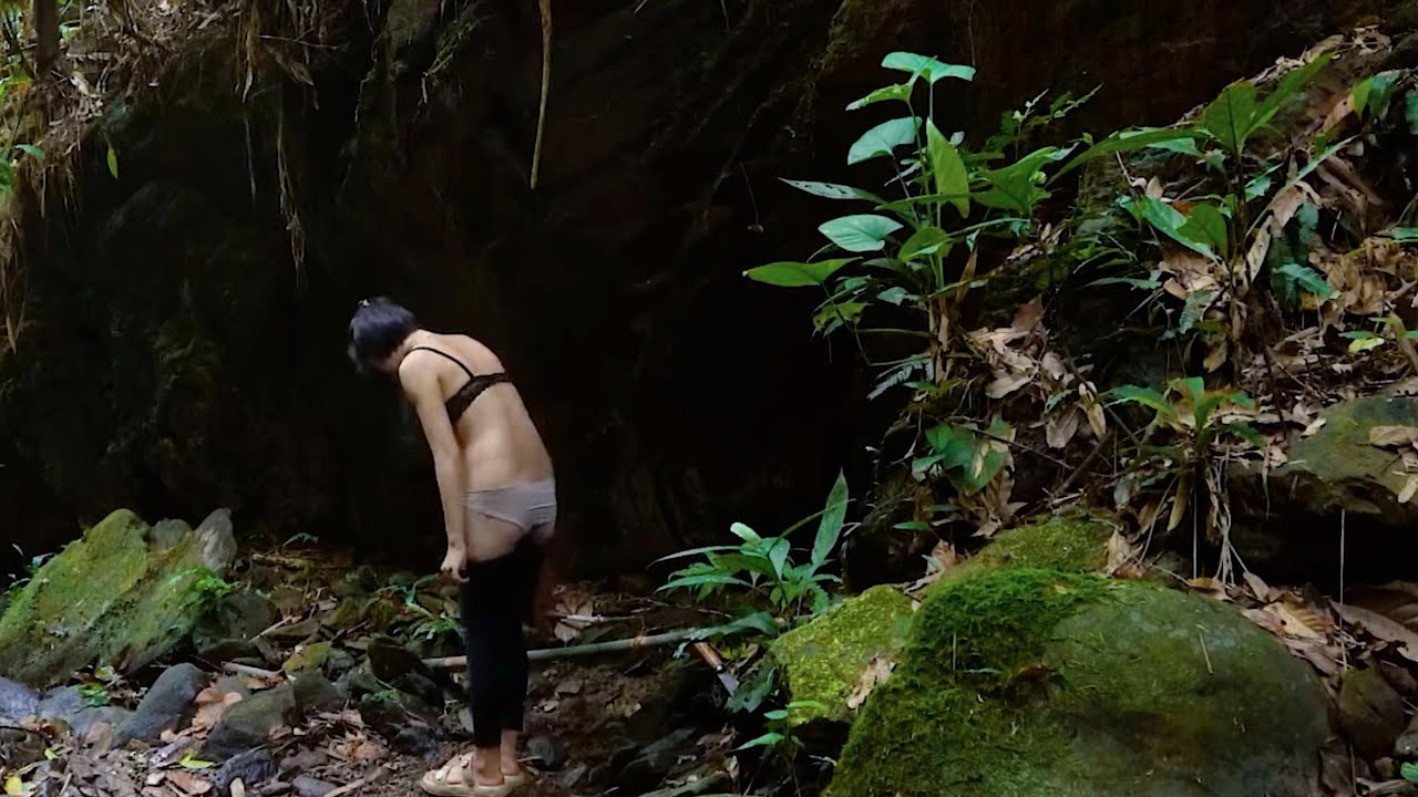 The young girl builds a shelter in a cave to survive in the wild and ...