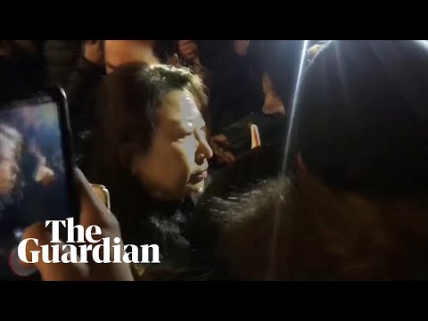 Hong Kong minister falls to the ground after being mobbed in London