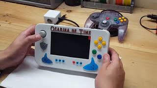 Downings Not-So-Single Game N64 Portable
http://downingsbasement.com
See the original version of the system here! https://www.youtube.com/watch?v=4CdQN_8dOjI
So in a rather interesting series of events, an old project from nearly 3 years ago ended up traveling the country before returning home for a big reboot and got sent right back on its way again!
Essentially, after I sold this Single Game system on eBay at the end of 2016, it found a new home with a few different buyers, but the latest somehow found my contact info and asked if Id be able to upgrade it for him.
The video explains the details, but bottom line, the once single-game system now plays every single N64 game thats been made, all built-in! Its a wonderful time we live in. haha! Downings Not-So-Single Game N64 Portable