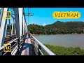 Riding a motorbike along the narrowest path on a railway bridge. Nha Trang, Vietnam. [4K]