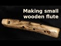 Making small wooden flute from branch