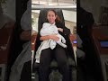Cinthya breastfeeding in a massage chair at the mall
