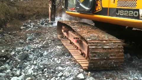 JCB Excavator Breaking Rock