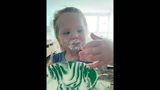 Girl Loves Eating Yogurt as It Covers Her Entire Mouth