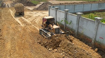 update new road foundation build technique skills dozer operator pushing soil dirt and dump tuck.