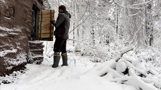 Staying in a shelter during a snowstorm. Spending the night in a bushcraft shelter. winter camping