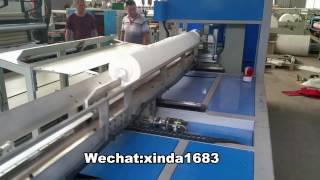 Automatic maxi roll rewinding machine with the automatic band saw cutting machine