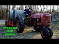 Predator 212 tractor, hauling rolls of hay.