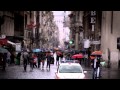 Slow motion footage of people walking down a wet street in Rome