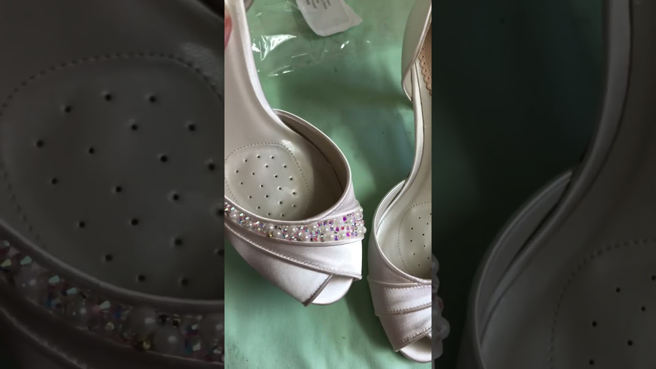 Adding crystals and pearls to shoes.