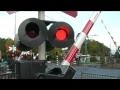 Train passes by very quickly at railroad crossing  spoorwegovergang in bilthoven