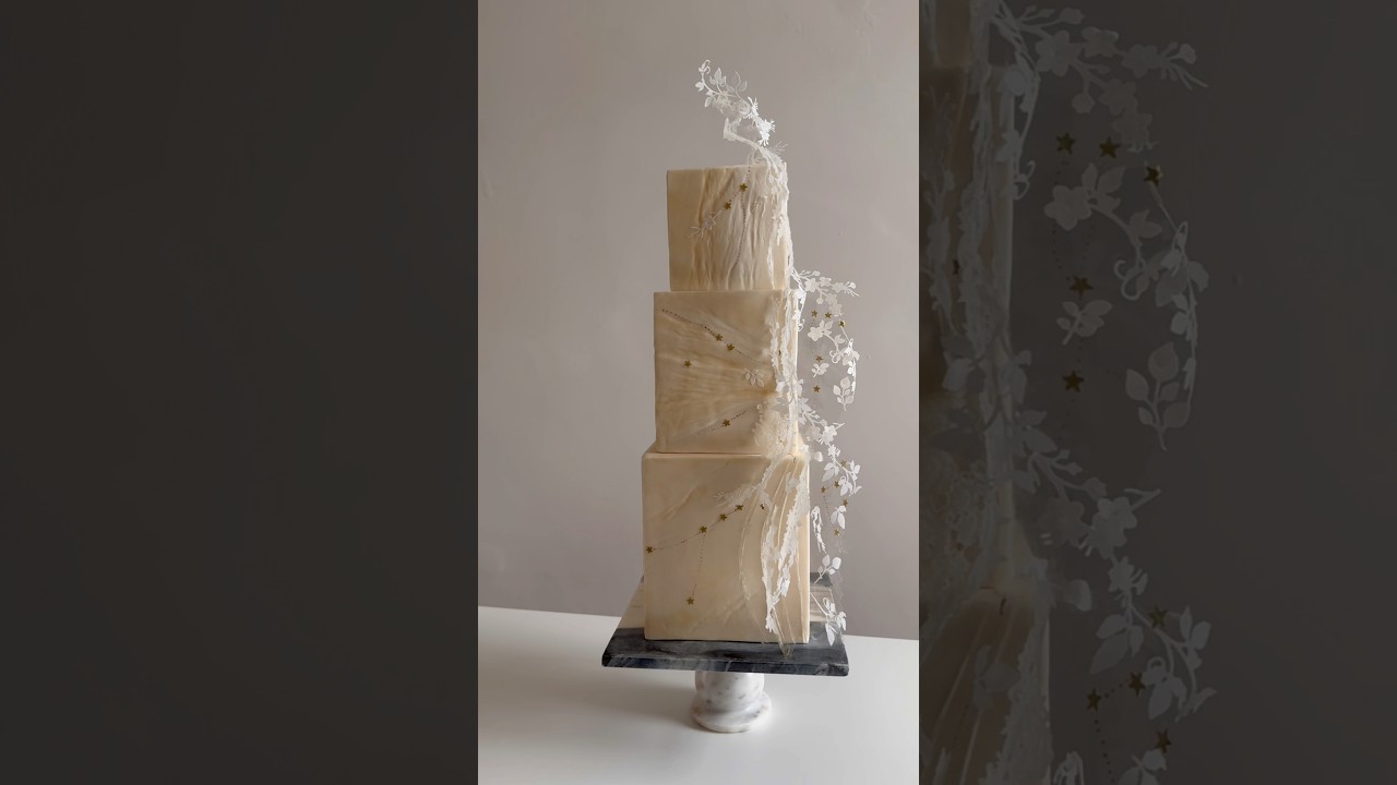 Edible lace on edible acetate with wafer paper and hand painted edible gold accents on fondant cake