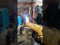 USING STICK WELDING PROCESS DURING FRONT LOADER AXLE REPAIR IN MECHANICAL WORKSHOP