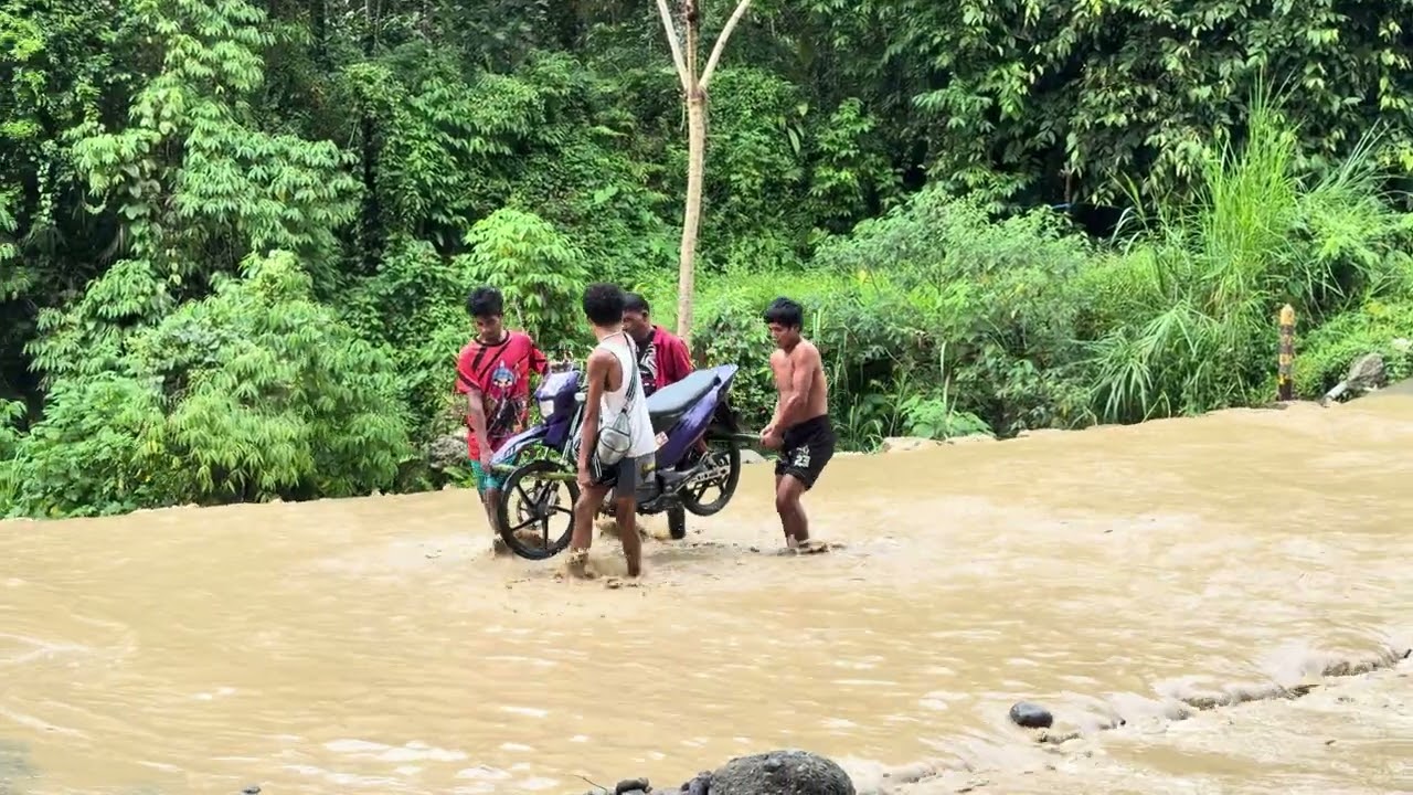 Carrying a Motorcycle Across Receding Marbol River
